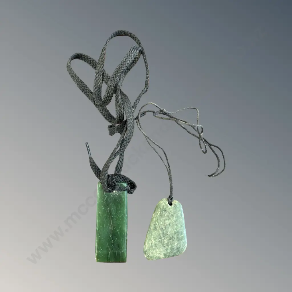 Two Greenstone Pendants on Cord, pendant size L6.5x2.5cm, L4.5x3.5cm Image 1++